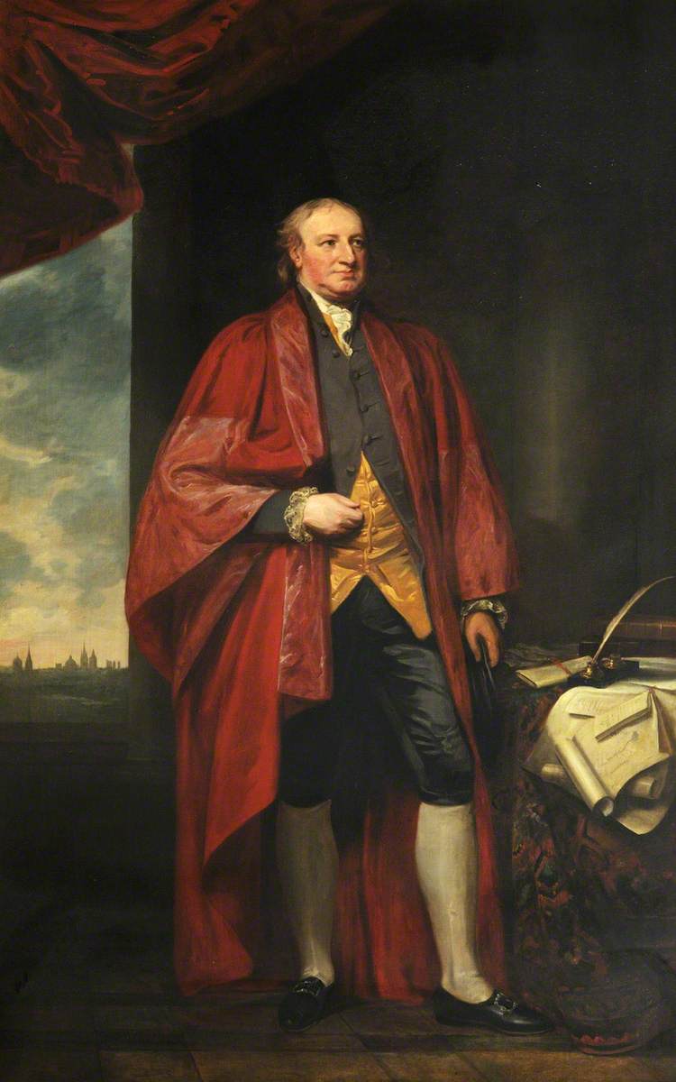 A painting of a white man stood up with his head looking towards his left. He has thinning dark hair and is wearing a black and gold waistcoat, black trousers, black shoes with buckles, and a red robe. To his left is a table covered in a dark patterned cloth. On top of the table are papers strewn across it and a quill and inkwell. The background is a dark room and a window in which a view of the top of church buildings and houses can be seen. It is a cloudy day.