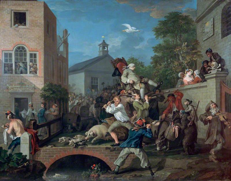 Painting showing a large crowd attending a chairing ceremony. A large man in a grey wig, pale green jacket and breeches is sat on a wooden chair with red upholstery. The chair is being carried in the air on the shoulders of a number of men. Around the chairing are scenes of violence, with a number of men fighting with wooden batons, a man passed out in a barrel, a woman is being given smelling salts after fainting. A huge crowd follows behind the chair into the distance. A number of animals, including pigs, a bear and a monkey are running through the crowd.