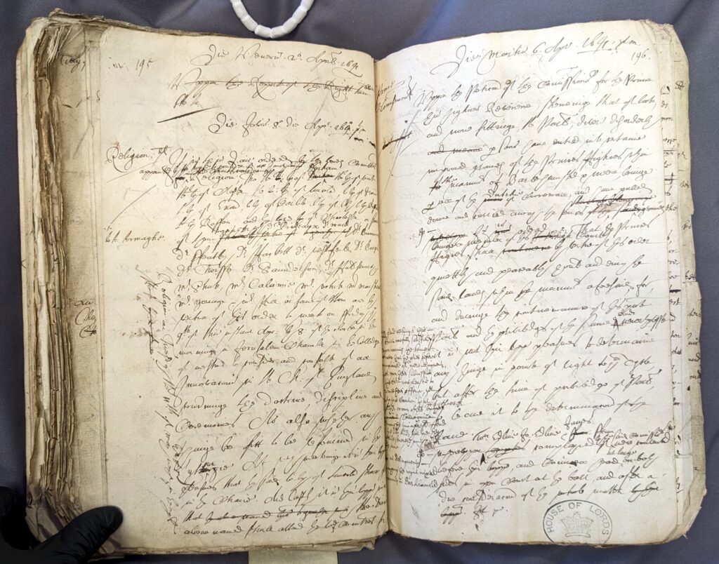 A coloured photograph of a manuscript page of handwritten text in Latin across two pages. The writing is illegible but concerns entries from 1641 in the Book of Orders.