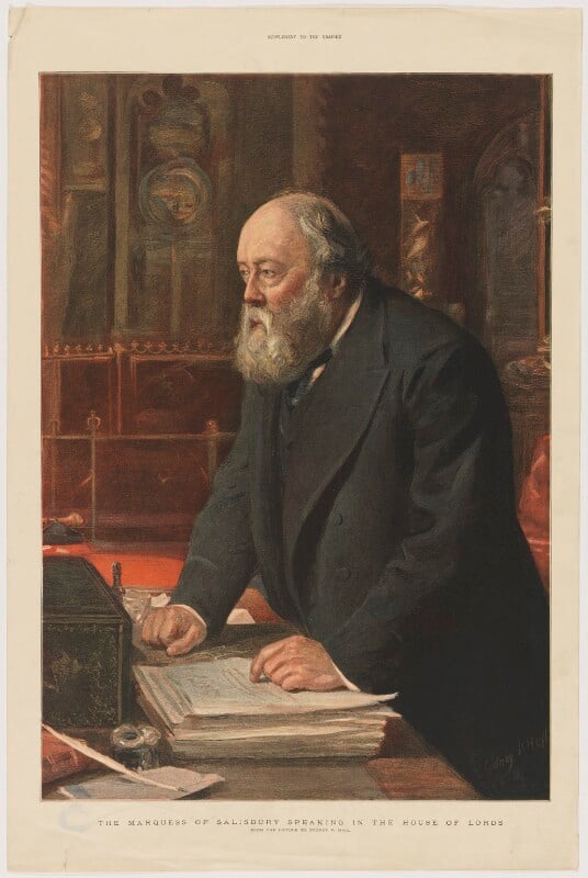 A half-length portrait of Robert Gascoyne-Cecil, 3rd Marquess of Salisbury, former Prime Minister, speaking in the House of Lords. Standing at the despatch box , he has his right hand on the table, and his left on top of a large stack of papers, Looking to the left, he is wearing a black Victorian suit, with a thick black suit coat. waistcoat, black tie and white collared shirt. He is bald with medium length grey hair on the back and sides of his head, as well as a full bushy grey beard.